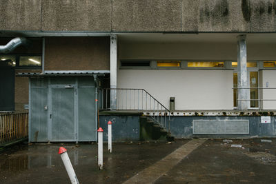 Wet footpath by building in city