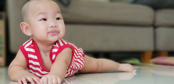 Portrait of cute boy sitting at home