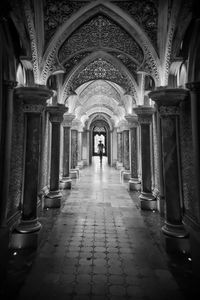 Man walking in corridor of building