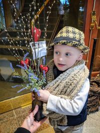 Portrait of boy holding christmas tree