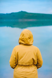 Rear view of woman standing against sky