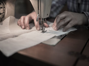 Midsection of woman sewing textile