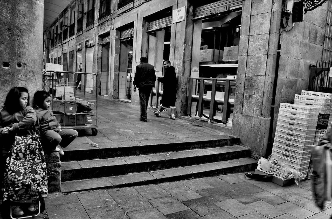 building exterior, architecture, men, built structure, lifestyles, person, walking, street, city, full length, leisure activity, rear view, city life, building, cobblestone, day, sunlight