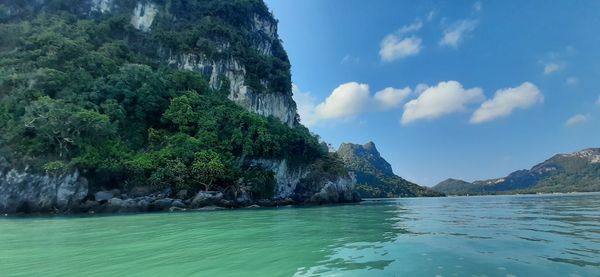 Scenic view of sea and mountains against sky