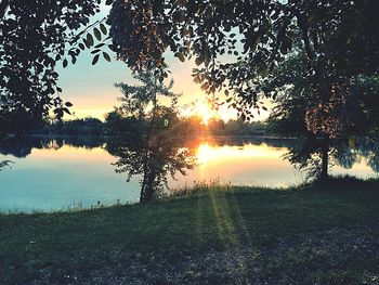 Scenic view of lake against sky during sunset