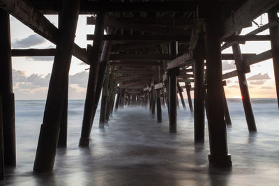 Low angle view of bridge at calm sea