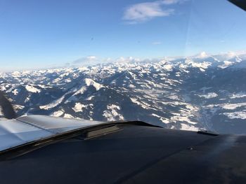 Aerial view of snowcapped mountains against sky