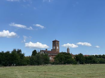 Built structure on field against sky