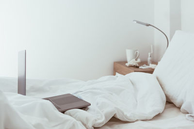 White blanket on bed at home