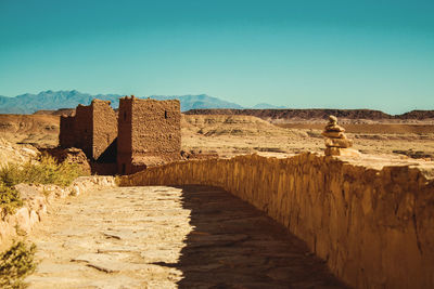 View of old ruins on desert against clear sky