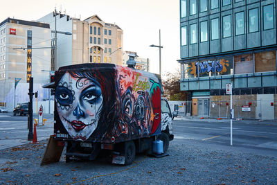 Graffiti on food truck parked at roadside in city