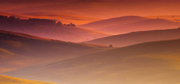 Scenic view of mountains against sky at sunset