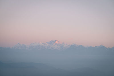 Scenic view of snowcapped mountains against sky during sunset