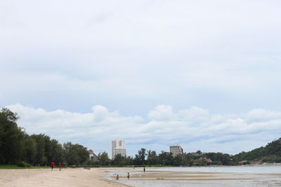 View of beach against cloudy sky