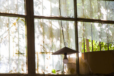 Old windows in old building and light equipment in factory, sunlight