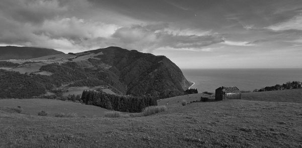 Scenic view of desert against dramatic sky