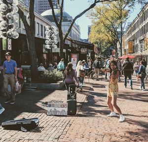 People in town square against sky