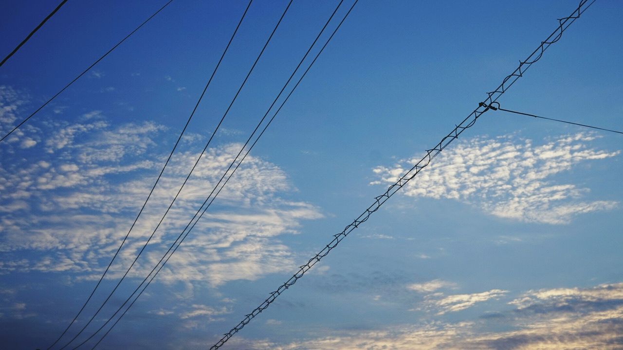 power line, low angle view, cable, electricity, power supply, electricity pylon, connection, sky, blue, fuel and power generation, technology, cloud - sky, power cable, cloud, complexity, outdoors, no people, nature, day, tranquility