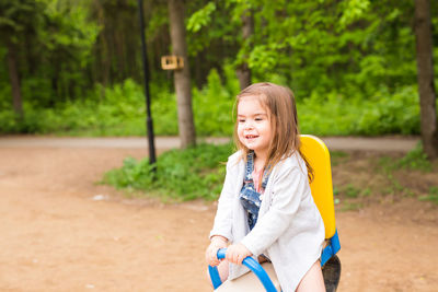 Portrait of smiling girl against trees