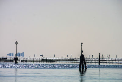 Man on sea against clear sky