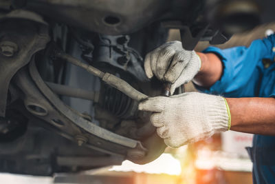 Midsection of man working in car