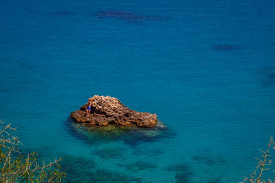 High angle view of rocks in sea