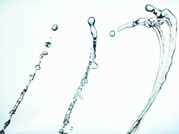 Low angle view of water drops against sky