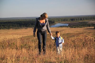 Full length of father and daughter on field