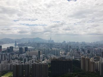 High angle view of cityscape against cloudy sky