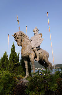 Low angle view of equestrian statue against clear sky