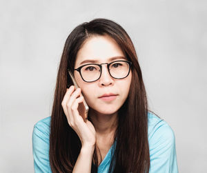 Portrait of a beautiful young woman against white background