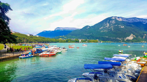 Boats in sea with mountain range in background