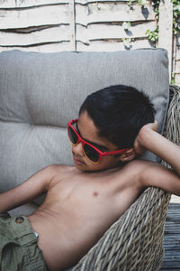 Midsection of boy sitting on chair