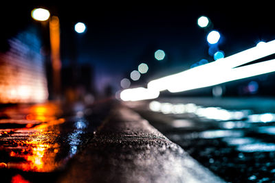 Defocused image of illuminated city against sky at night