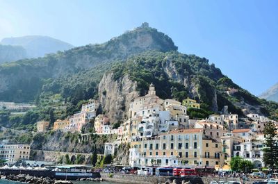 High angle view of townscape by mountain against sky