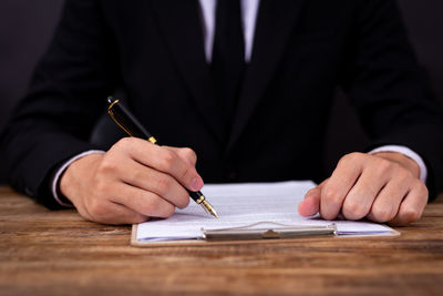 Cropped image of man holding glass table