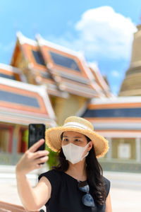 Portrait of young woman using mobile phone