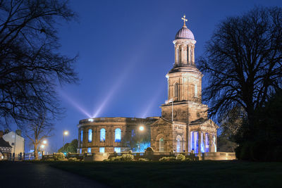 Low angle view of illuminated building church against sky at night