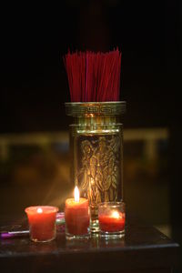 Close-up of lit tea light candles on table