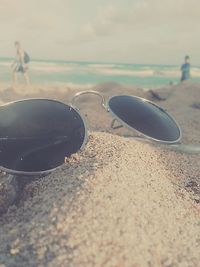 Close-up of beach against sky