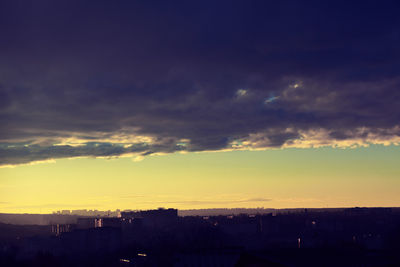 Silhouette buildings against sky during sunset