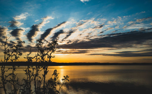 Scenic view of lake against romantic sky at sunset