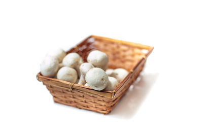 Close-up of wicker basket over white background