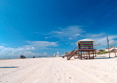 Scenic view of beach against blue sky
