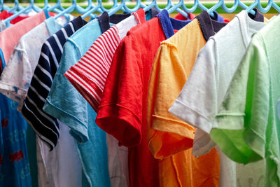 Full frame shot of colorful clothes hanging on rack in store