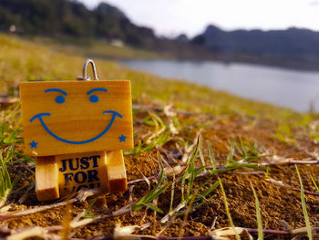 Close-up of information sign on field