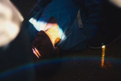 Close-up of hand holding lit candle