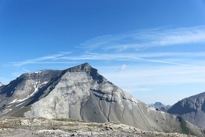 Scenic view of mountain against blue sky