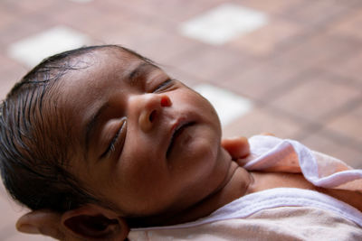Close-up of a new borne boy child sleeping on his mother's hand