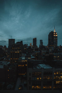 High angle view of illuminated buildings against sky at dusk